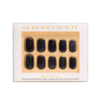 Glam Haus Beauty press-on nails, black color, short square shaped nails with Glam Haus Beauty packaging with gold and white design.