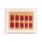 Glam Haus Beauty press-on nails, red color, short square shaped nails with Glam Haus Beauty packaging with gold and white design.
