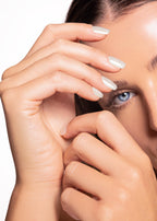 female model showing hand and nails. nail color white. nail shape short square
